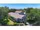Two-story home featuring a covered front porch, mature trees, and a well-maintained lawn at 6002 Churchside Dr, Lithia, FL 33547