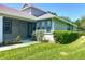 Charming home with blue shutters and a lovely screened porch surrounded by green lawn at 6002 Churchside Dr, Lithia, FL 33547