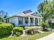 Attractive home with a covered front porch, defined by white columns and a well-manicured lawn at 6002 Churchside Dr, Lithia, FL 33547