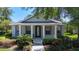 Charming single-story home featuring a welcoming front porch with white columns and lush landscaping at 6002 Churchside Dr, Lithia, FL 33547