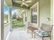 Inviting front porch with seating, perfect for relaxing and enjoying the neighborhood views with a ceiling fan at 6002 Churchside Dr, Lithia, FL 33547