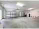 Spacious garage with multiple garage doors and ample space for parking and storage at 6002 Churchside Dr, Lithia, FL 33547