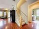 Hallway showcasing hardwood floors, access to the staircase, and a laundry room with appliances at 6002 Churchside Dr, Lithia, FL 33547