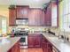 A kitchen featuring stainless steel appliances, dark wood cabinetry, and a sink with a window view at 6002 Churchside Dr, Lithia, FL 33547