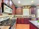 An inviting kitchen with stainless steel appliances, wood cabinets, and a view of the sink and island at 6002 Churchside Dr, Lithia, FL 33547