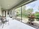 View of the screened lanai with seating, offering a serene view of the landscaped backyard at 6002 Churchside Dr, Lithia, FL 33547