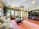 Bright living room featuring hardwood floors, a decorative rug, sofa, and entertainment center at 6002 Churchside Dr, Lithia, FL 33547