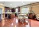 Open kitchen, dining area, and living room featuring hardwood floors and modern decor at 6002 Churchside Dr, Lithia, FL 33547