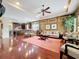 Bright living room featuring hardwood floors, stylish decor, and an open layout into the kitchen at 6002 Churchside Dr, Lithia, FL 33547