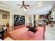 Spacious living room featuring hardwood floors, a ceiling fan, and an open layout into the kitchen at 6002 Churchside Dr, Lithia, FL 33547