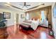 Relaxing main bedroom features natural lighting, a tray ceiling, and hardwood flooring at 6002 Churchside Dr, Lithia, FL 33547