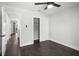 Bright bedroom with hardwood floors, ceiling fan, closet and view to a hallway at 6361 23Rd N St, St Petersburg, FL 33702