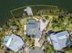 Exclusive waterfront property featuring a private dock, pool, lush landscaping, and expansive outdoor living spaces at 6614 Blackfin Way, Apollo Beach, FL 33572