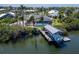 Waterfront property with a private boat dock, screened pool area, and beautiful landscaping at 6614 Blackfin Way, Apollo Beach, FL 33572