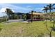 Backyard featuring a covered outdoor kitchen, lanai and green yard at 6614 Blackfin Way, Apollo Beach, FL 33572