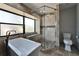 Bright bathroom featuring tub, stone shower and window at 6614 Blackfin Way, Apollo Beach, FL 33572