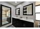 Bright bathroom features dual vanity, tub and shower combination and sleek dark cabinetry at 6614 Blackfin Way, Apollo Beach, FL 33572