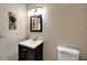 Neutral half bathroom featuring a pedestal sink, dark cabinets and tile flooring at 6614 Blackfin Way, Apollo Beach, FL 33572