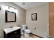 Simple half bathroom with vanity sink, framed mirror, and tiled floors at 6614 Blackfin Way, Apollo Beach, FL 33572