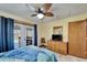 Bright bedroom features a ceiling fan, French doors to the outdoor area, and natural light at 6614 Blackfin Way, Apollo Beach, FL 33572