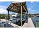 Boat lift and dock featuring a boat on the water at 6614 Blackfin Way, Apollo Beach, FL 33572