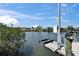 Boat lift on the water with scenic views of the surrounding homes and clear blue skies at 6614 Blackfin Way, Apollo Beach, FL 33572