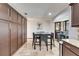 A dining room featuring modern appliances, dark brown cabinets, and stylish seating at 6614 Blackfin Way, Apollo Beach, FL 33572