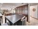 A dining room features modern appliances, dark brown cabinets, and stylish seating at 6614 Blackfin Way, Apollo Beach, FL 33572