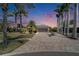 Beautiful front exterior view showcases landscaping and brick driveway at 6614 Blackfin Way, Apollo Beach, FL 33572