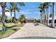 Beautiful single-story home featuring a paver driveway, lush landscaping, and an attached two-car garage at 6614 Blackfin Way, Apollo Beach, FL 33572