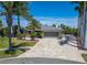 Beautiful single-story home featuring a paver driveway, lush landscaping, and an attached two-car garage at 6614 Blackfin Way, Apollo Beach, FL 33572