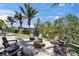 Cozy outdoor fire pit area with Adirondack chairs, perfect for evening gatherings and relaxation at 6614 Blackfin Way, Apollo Beach, FL 33572