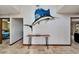 Stylish entryway with a unique fish art piece and sleek wooden console table at 6614 Blackfin Way, Apollo Beach, FL 33572