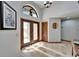 Foyer with tiled floor, a front door with sidelights, transom window, and chandelier at 6614 Blackfin Way, Apollo Beach, FL 33572