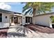 Inviting entryway with a double front door, decorative sconces, and tiled walkway at 6614 Blackfin Way, Apollo Beach, FL 33572