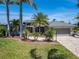 Beautiful home with lush landscaping, mature palm trees, and an inviting front entrance at 6614 Blackfin Way, Apollo Beach, FL 33572