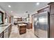 A spacious kitchen offers stainless steel appliances, dark wood cabinets, and an island at 6614 Blackfin Way, Apollo Beach, FL 33572