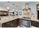 Open kitchen with stainless steel appliances, granite countertops, and views of living area at 6614 Blackfin Way, Apollo Beach, FL 33572