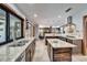 An open-concept kitchen features stainless steel appliances, granite counters, and an island at 6614 Blackfin Way, Apollo Beach, FL 33572