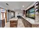 A modern kitchen with stainless steel appliances, dark wood cabinets, and an island at 6614 Blackfin Way, Apollo Beach, FL 33572