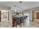 Kitchen breakfast bar seating three with wine racks and outdoor pool view at 6614 Blackfin Way, Apollo Beach, FL 33572