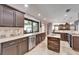 Kitchen with granite counters, stainless steel appliances, island, and bar cabinet at 6614 Blackfin Way, Apollo Beach, FL 33572