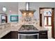 Updated kitchen features stainless steel appliances, granite countertops and a decorative tile backsplash at 6614 Blackfin Way, Apollo Beach, FL 33572