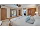 This bedroom features tiled floors, a ceiling fan and access to the pool via french doors at 6614 Blackfin Way, Apollo Beach, FL 33572