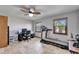 Office with travertine tile, dual windows, ceiling fan, desk and a treadmill at 6614 Blackfin Way, Apollo Beach, FL 33572