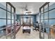 Office with travertine tile, blue walls, ceiling fan, shutters, leather sofa and desk at 6614 Blackfin Way, Apollo Beach, FL 33572