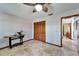 Office with travertine tile, ceiling fan, sewing machine and a closet with shuttered doors at 6614 Blackfin Way, Apollo Beach, FL 33572