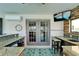 Outdoor bar area with granite countertops and a television, perfect for entertaining at 6614 Blackfin Way, Apollo Beach, FL 33572