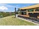 Outdoor kitchen and lanai with stone tiling, grill and sink overlooking backyard at 6614 Blackfin Way, Apollo Beach, FL 33572