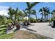Paver patio with comfortable outdoor seating surrounded by lush landscaping and palm trees at 6614 Blackfin Way, Apollo Beach, FL 33572
